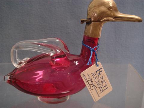 Appraisal: Cranberry glass duck cruet clear glass handles hinged brass head