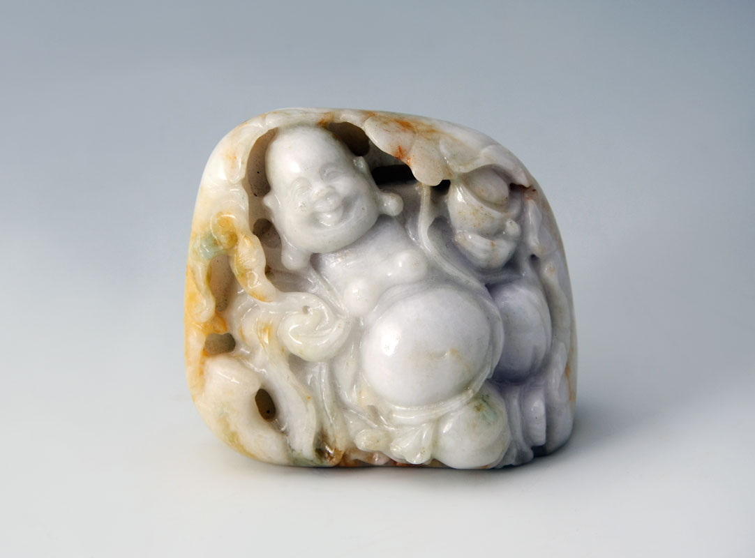 Appraisal: CHINESE CARVED JADEITE BUDDHA BOULDER Carved white apple and brown