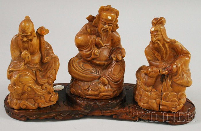 Appraisal: Three Asian Carved Wooden Seated Immortals Figures