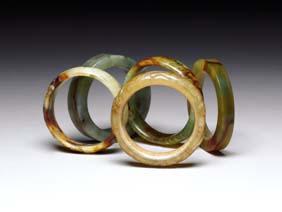 Appraisal: FIVE HARDSTONE BANGLES Five Chinese carved hardstone bangles white with