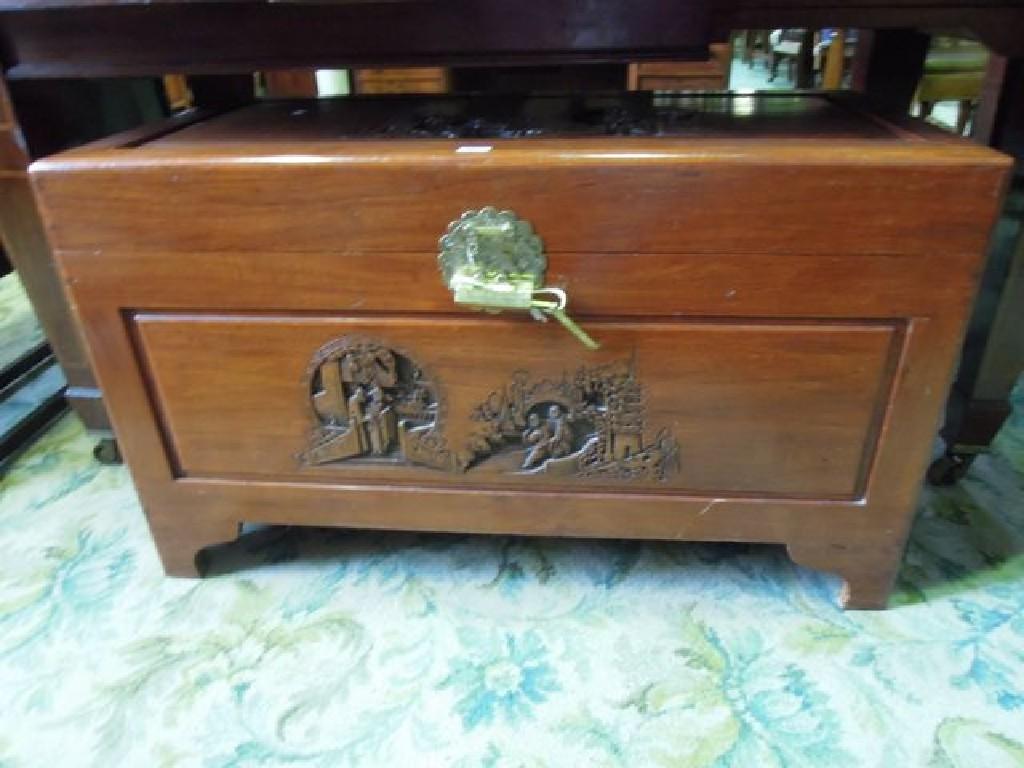 Appraisal: An Eastern camphor wood box with carved reserve panelled detail