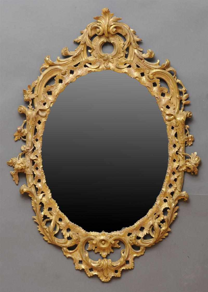 Appraisal: GEORGE II CARVED GILTWOOD OVAL PIER MIRROR The oval mirror