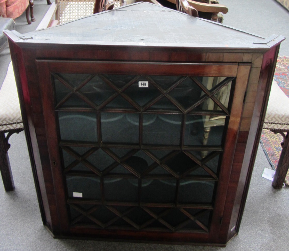 Appraisal: A George III mahogany hanging corner cupboard with single astragal