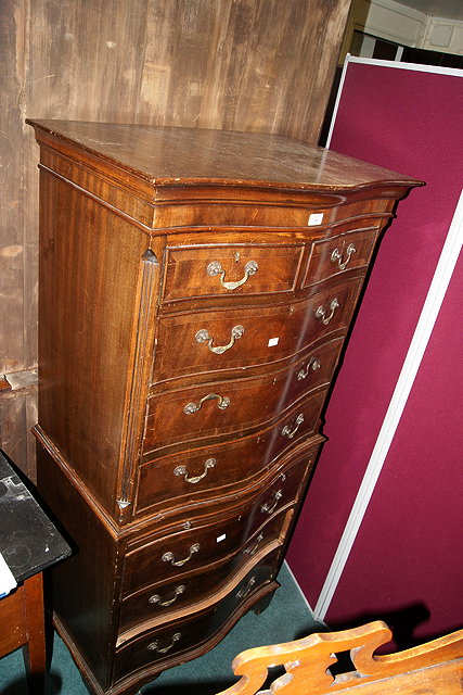 Appraisal: A REPRODUCTION MAHOGANY SMALL TALLBOY fitted drawers with shaped front