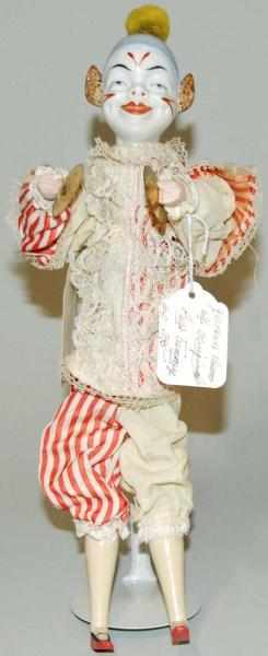 Appraisal: German Clown China Head Doll Mechanical Pressing on his chest