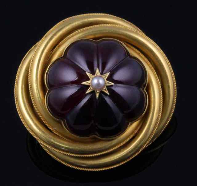 Appraisal: A Victorian gold brooch centred by a lobed central stone