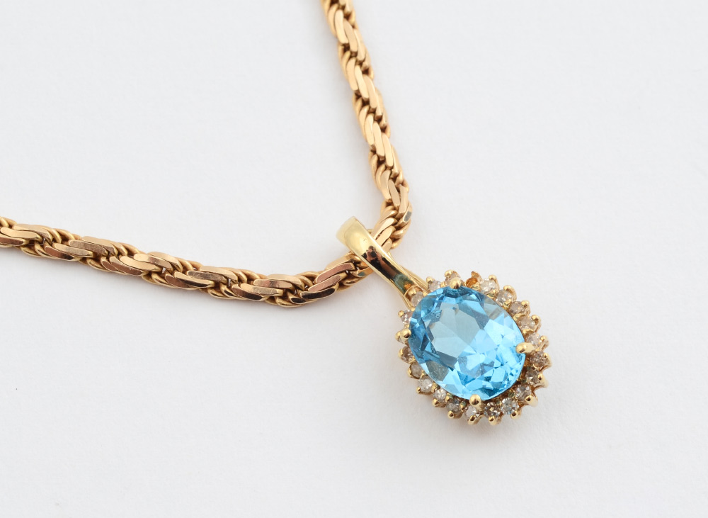 Appraisal: BLUE TOPAZ DIAMOND PENDANT CHAIN K yellow gold enhancer pendant