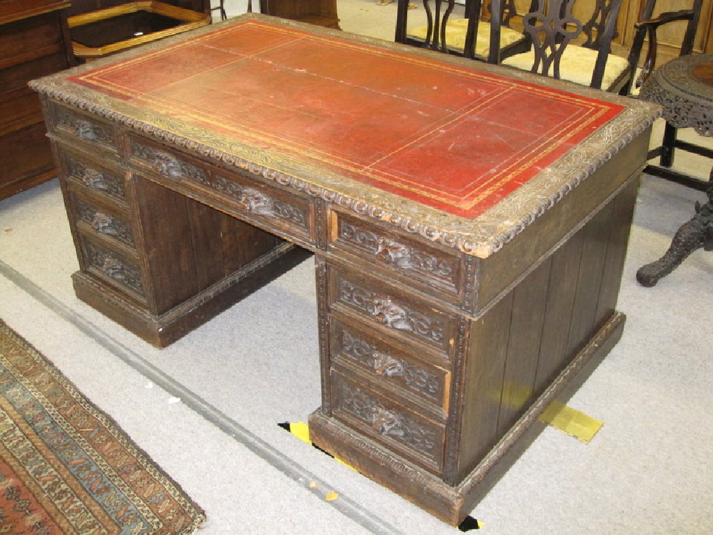 Appraisal: Carved oak twin pedestal partners desk the drawers with carved