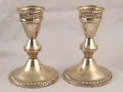 Appraisal: A pair of filled white metal tests silver candlesticks marked