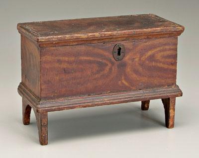 Appraisal: Miniature grain-painted blanket chest top with tang hinges interior with