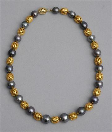 Appraisal: BLACK PEARL NECKLACE Strand of black baroque pearls alternated with