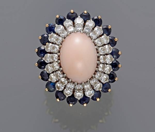 Appraisal: A coral sapphire and diamond ring estimated total diamond weight