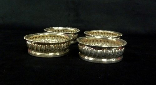 Appraisal: A set of four Sheffield plated wine coasters each of