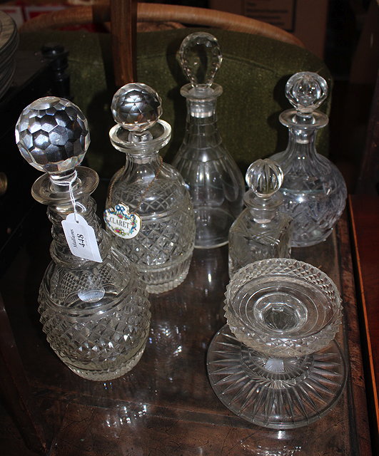 Appraisal: A GROUP OF CUT GLASS DECANTERS to include a silver