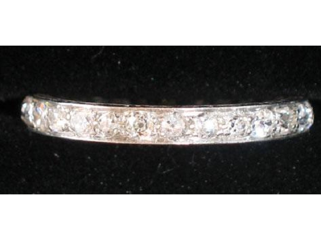 Appraisal: A DIAMOND ETERNITY RING set in chased white metal with