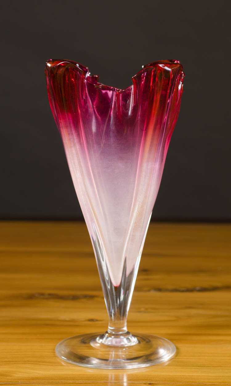 Appraisal: STEUBEN ART GLASS FOOTED VASE Grotesque form red rim shading