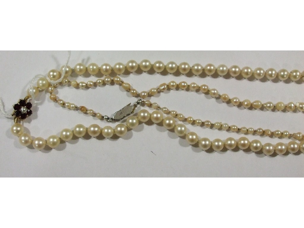 Appraisal: Long string of cultured pearls inches with ct gold garnet