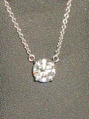 Appraisal: A SOLITAIRE DIAMOND NECKLACE the brilliant cut stone approximately cts