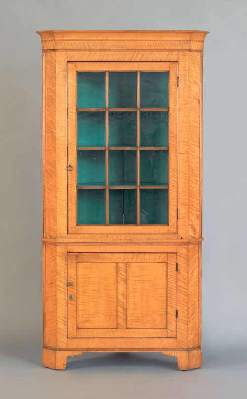 Appraisal: Pennsylvania tiger maple two part corner cupboard early th c