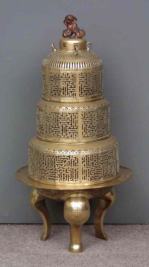 Appraisal: A Chinese circular brass brazier with three tiered pierced cover