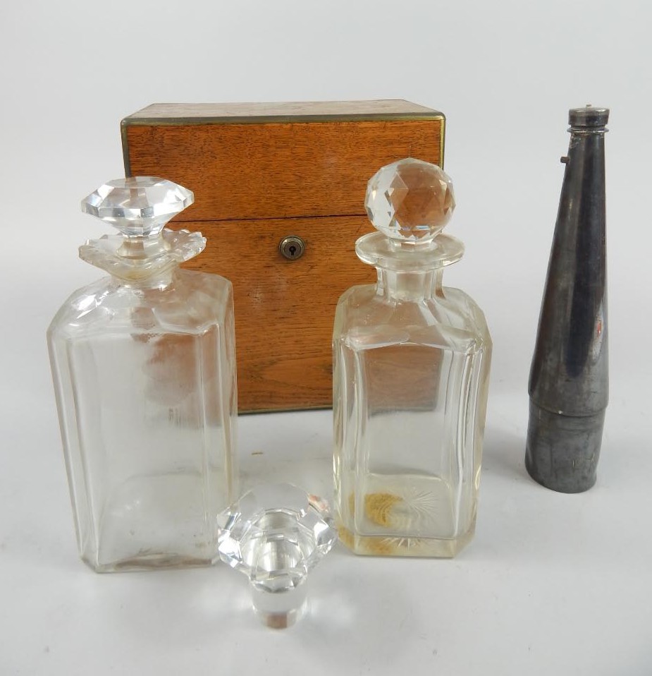 Appraisal: A two bottle tantalus with extra stopper the oak case