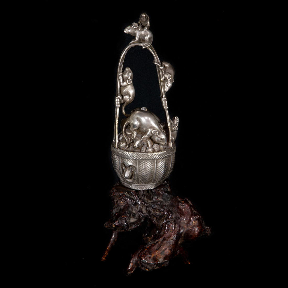 Appraisal: A JAPANESE SILVERED BRONZE OKIMONO OF FROLICKING MICE IN A