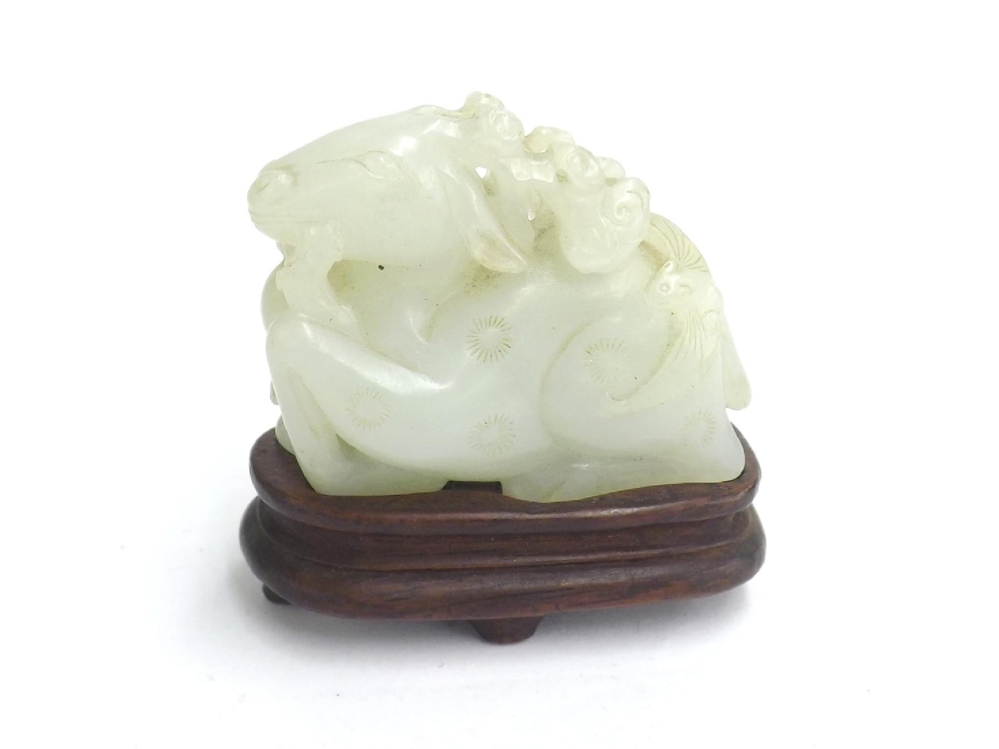 Appraisal: Carved jade of a recumbent deer upon a hardwood stand