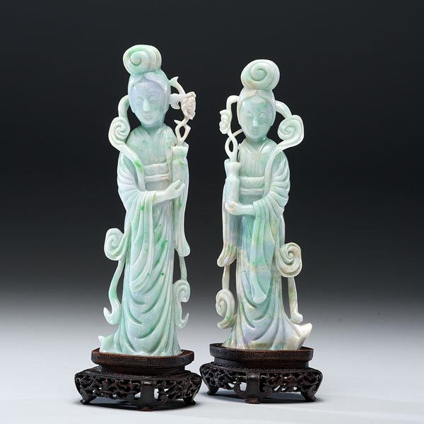 Appraisal: Chinese Two carved green and lavender jadeite Guanyin figures resting