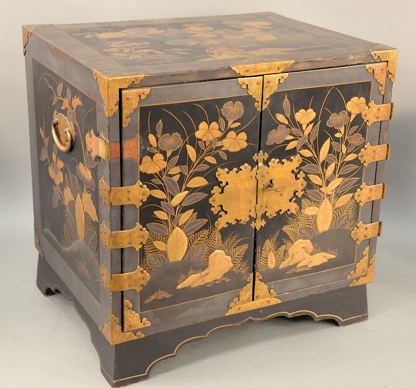 Appraisal: Japanese black lacquered cabinet having heavy paint gilt landscape with