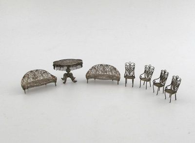 Appraisal: A seven piece silver filigree miniature furniture set comprising a