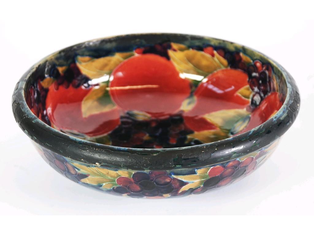 Appraisal: WILLIAM MOORCROFT POMEGRANATE PATTERN TUBE LINED POTTERY FRUIT BOWL steep