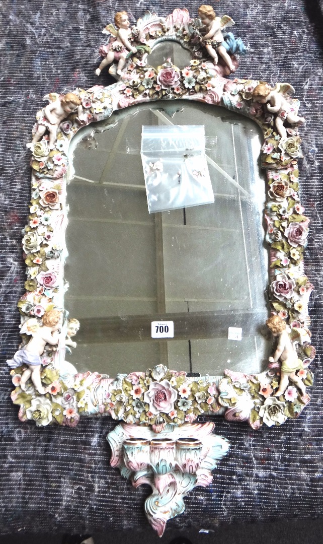 Appraisal: A Continental porcelain wall mirror early th century ornately decorated