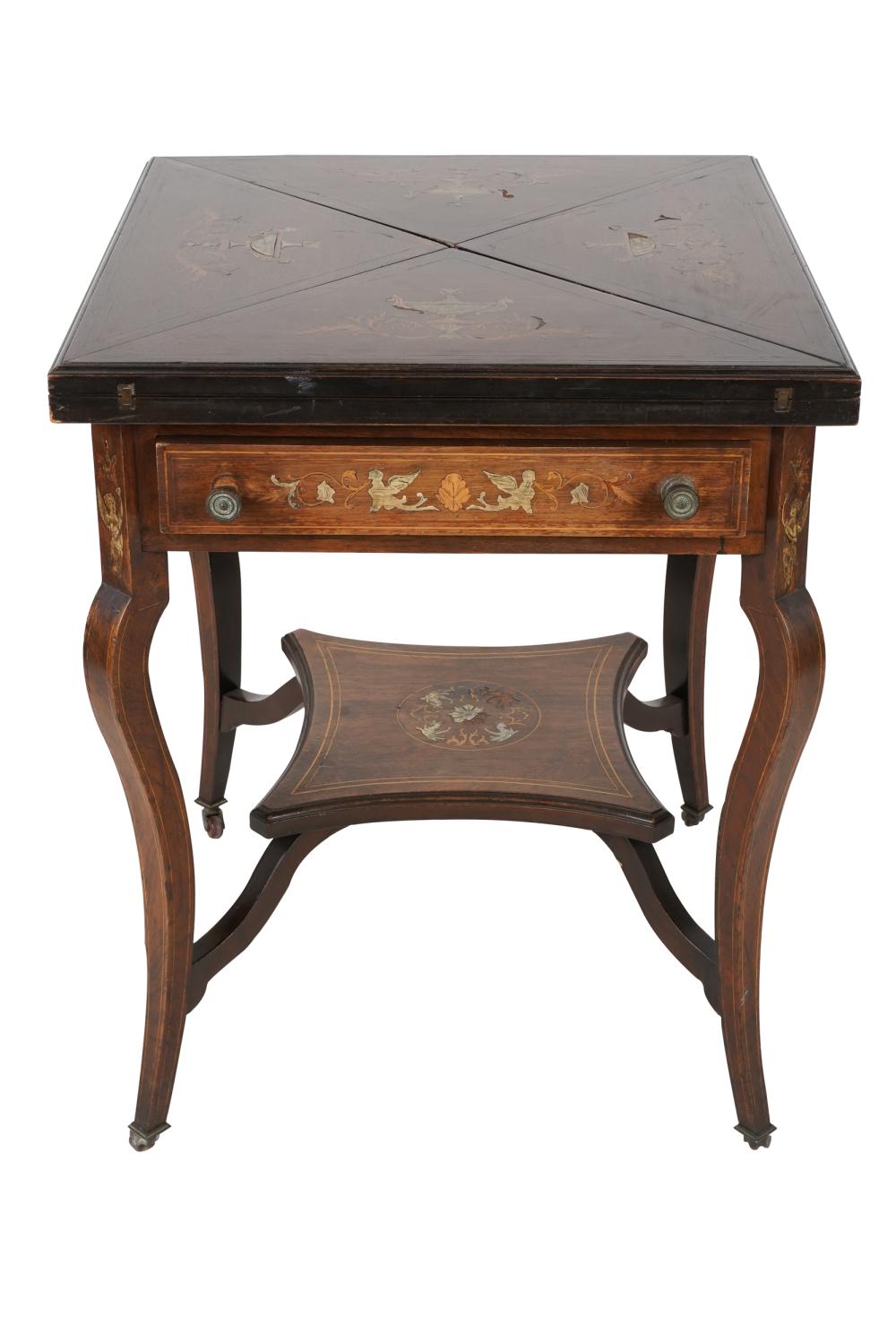 Appraisal: EDWARDIAN MARQUETRY-INLAID MAHOGANY GAMES TABLEthe swiveling handkerchief top inlaid with