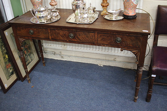 Appraisal: A WILLIAM IV MAHOGANY SIDE TABLE with three frieze drawers