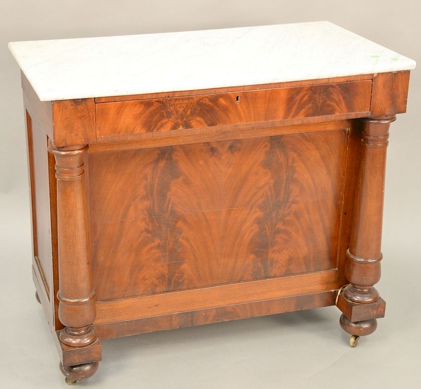 Appraisal: Empire mahogany server with marble top and side door opening