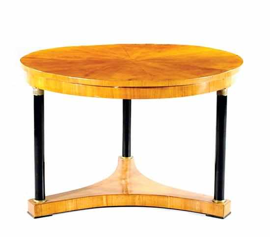 Appraisal: Biedermeier fruitwood center table sunburst top over ebonized columns leading