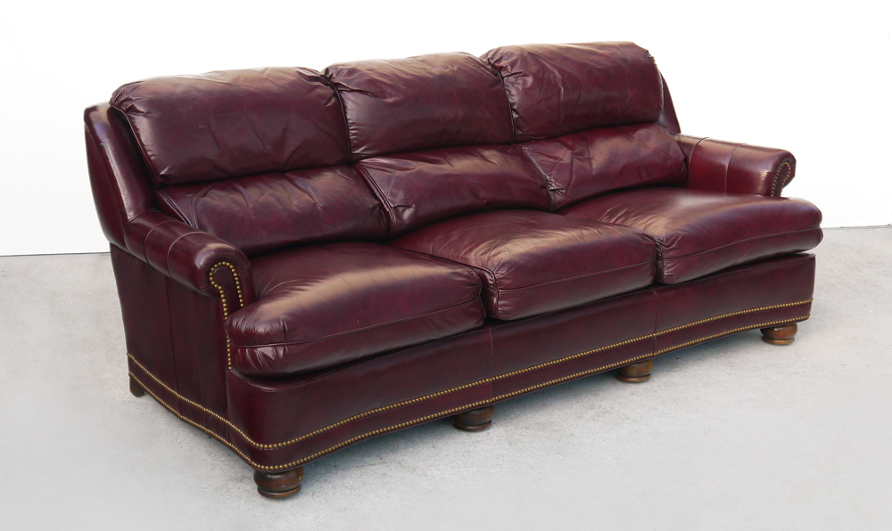 Appraisal: HANCOCK MOORE LEATHER SOFA Burgundy leather upholstery tacked arms base