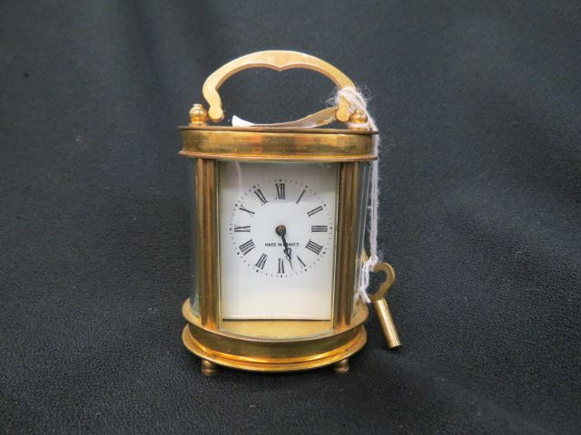 Appraisal: French Carriage Clock oval Roman numeral dial footed open top