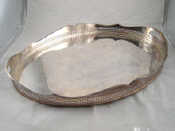 Appraisal: An oval silver plated two handled tray with gadrooned pierced