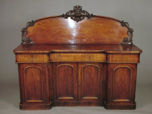 Appraisal: A Victorian mahogany inverted breakfront sideboard the raised arched panel