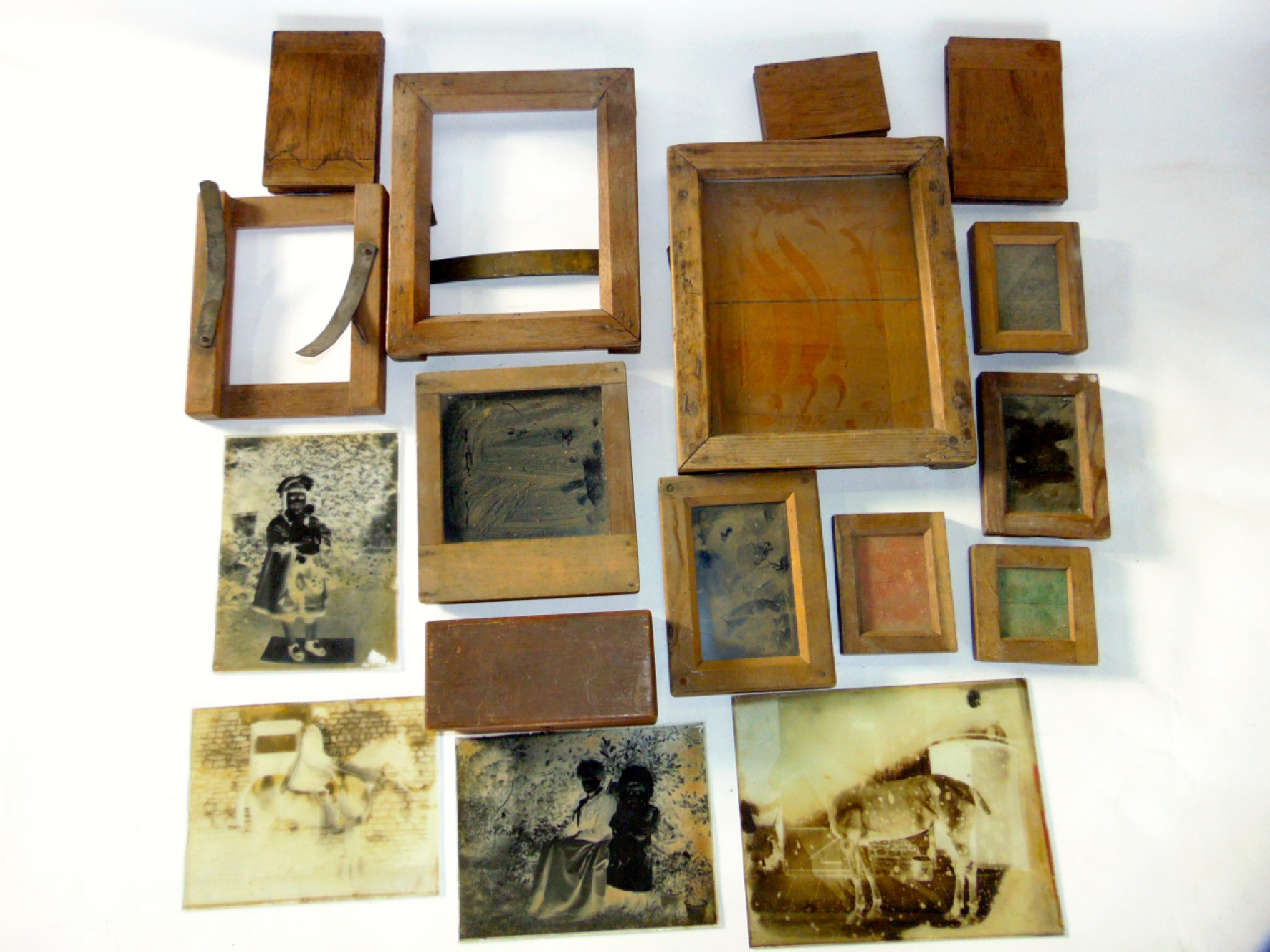 Appraisal: A th century photographic timber plate frames various glass plates