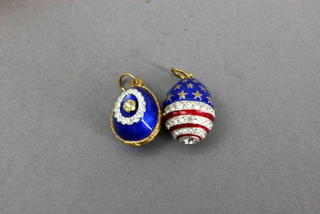 Appraisal: Two Faberge style enamel and paste egg pendants