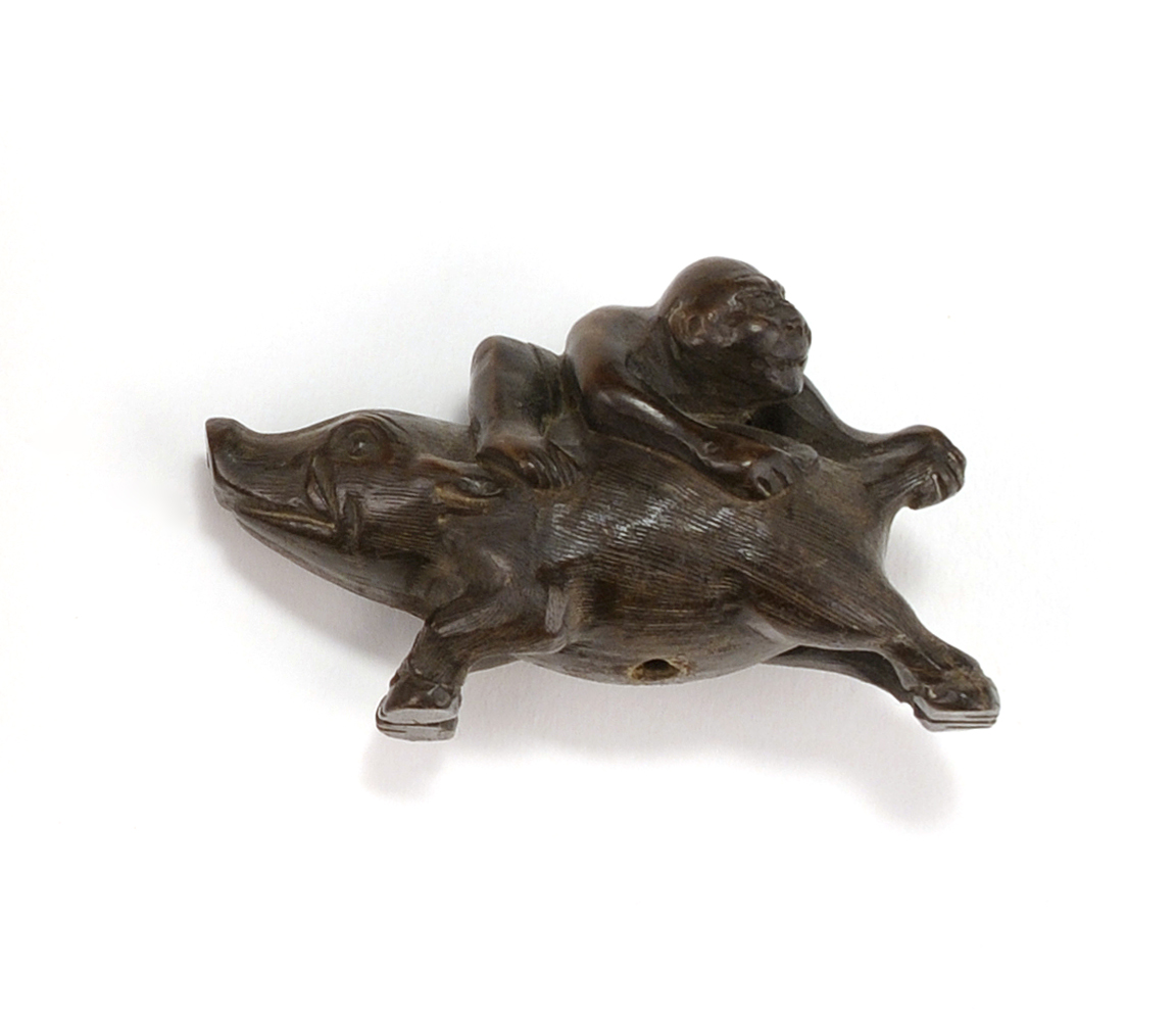 Appraisal: WOOD NETSUKE th CenturyDepicting a figure riding on a boar