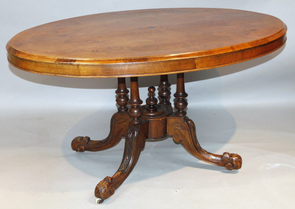 Appraisal: A Victorian walnut loo table the oval top partially inlaid