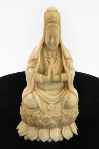 Appraisal: AN IVORY FIGURE of a seated figure hand carved from