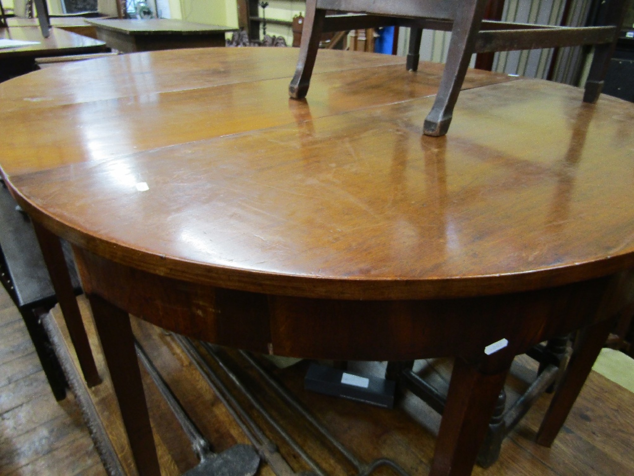 Appraisal: A Georgian mahogany dining table with two 'D' shaped ends