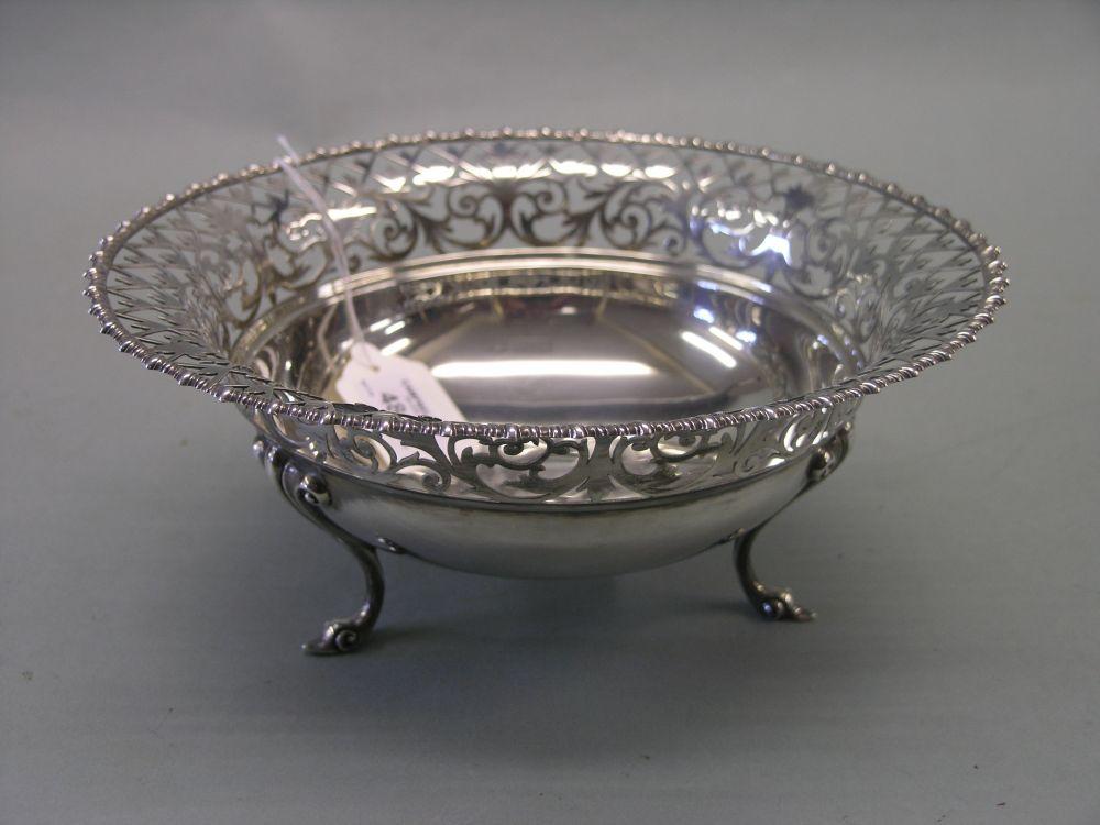 Appraisal: A silver fruit basket with elaborately pierced border on three