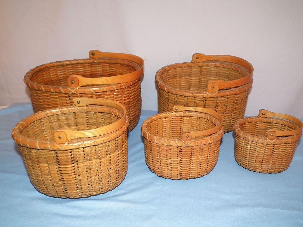 Appraisal: SET ARTHUR MARTIN NANTUCKET BASKETS Set of old graduated Nantucket