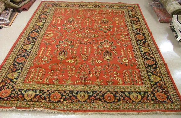 Appraisal: ORIENTAL INDO-SAROUK CARPET floral sprig motif across an expansive red