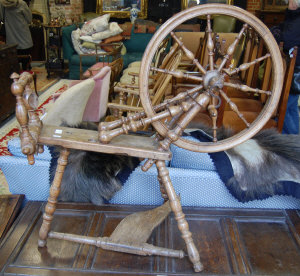 Appraisal: A turned oak spinning wheel with iron crank handle